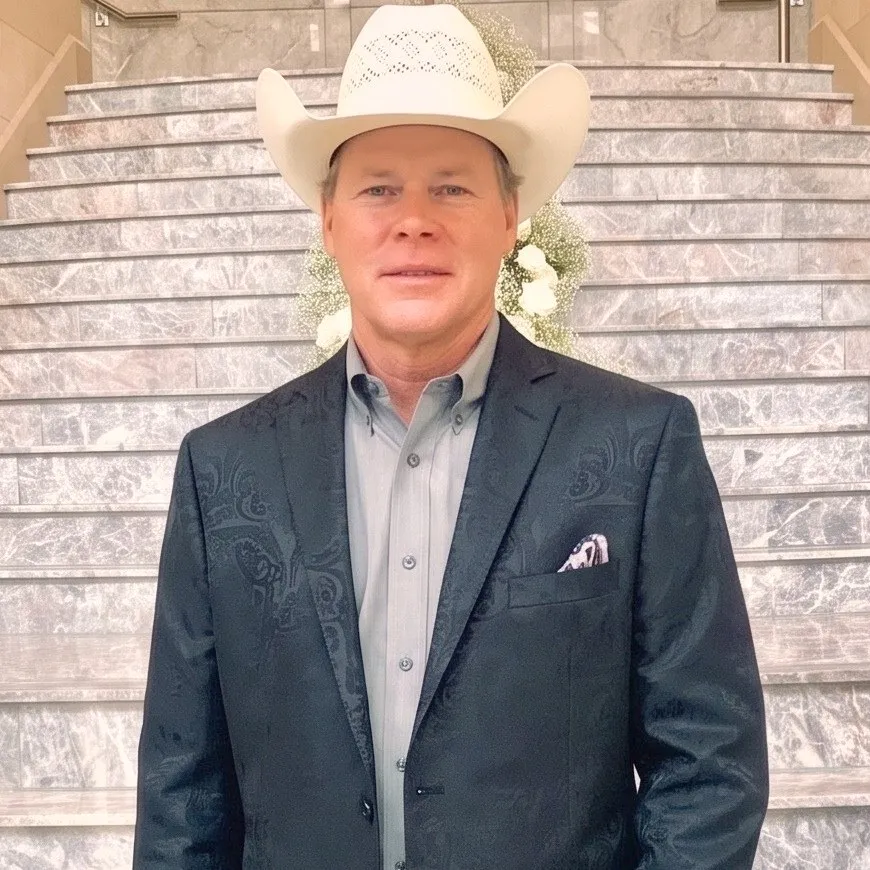 Bill South, owner of South Custom Lighting, in a straw cowboy hat and dark jacket