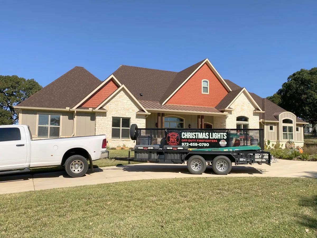 The truck and trailer on a job site, installed by South Custom Lighting in North Texas
