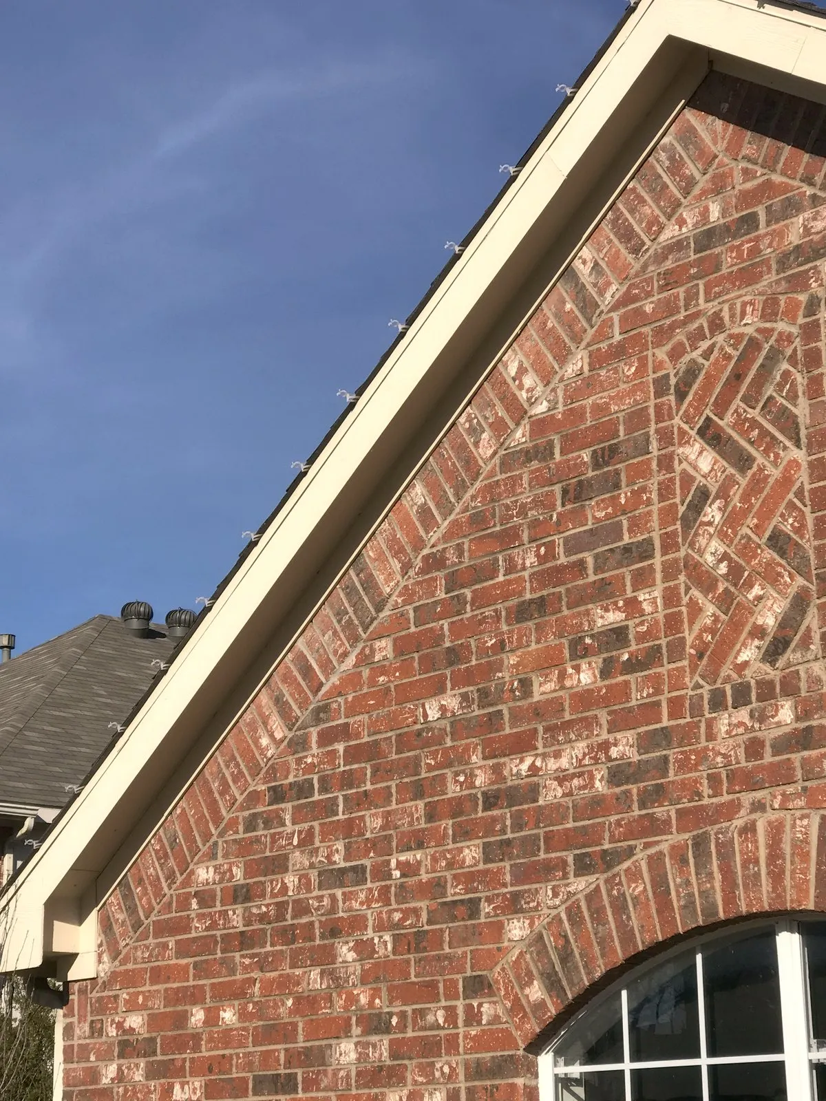 Clip line detail along a brick gable, installed by South Custom Lighting in North Texas