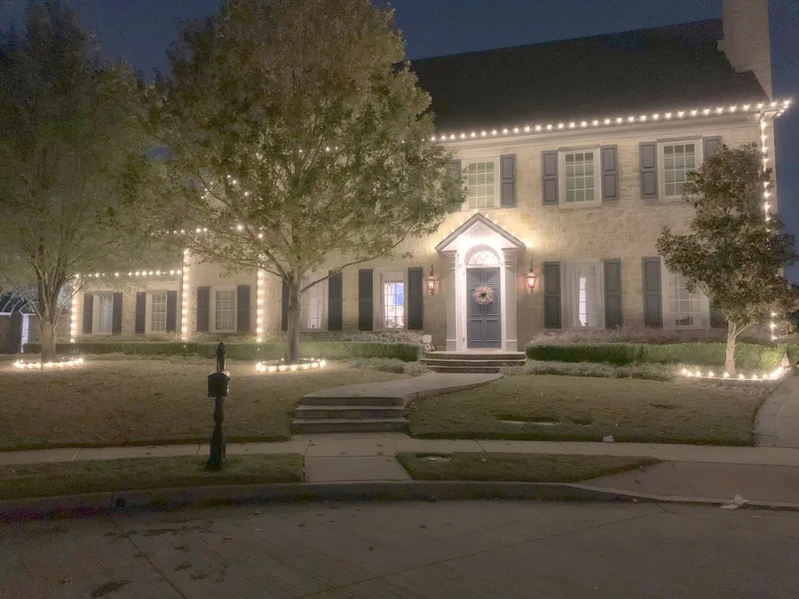 A colonial front with both entry trees wrapped trunk to tip, installed by South Custom Lighting in North Texas