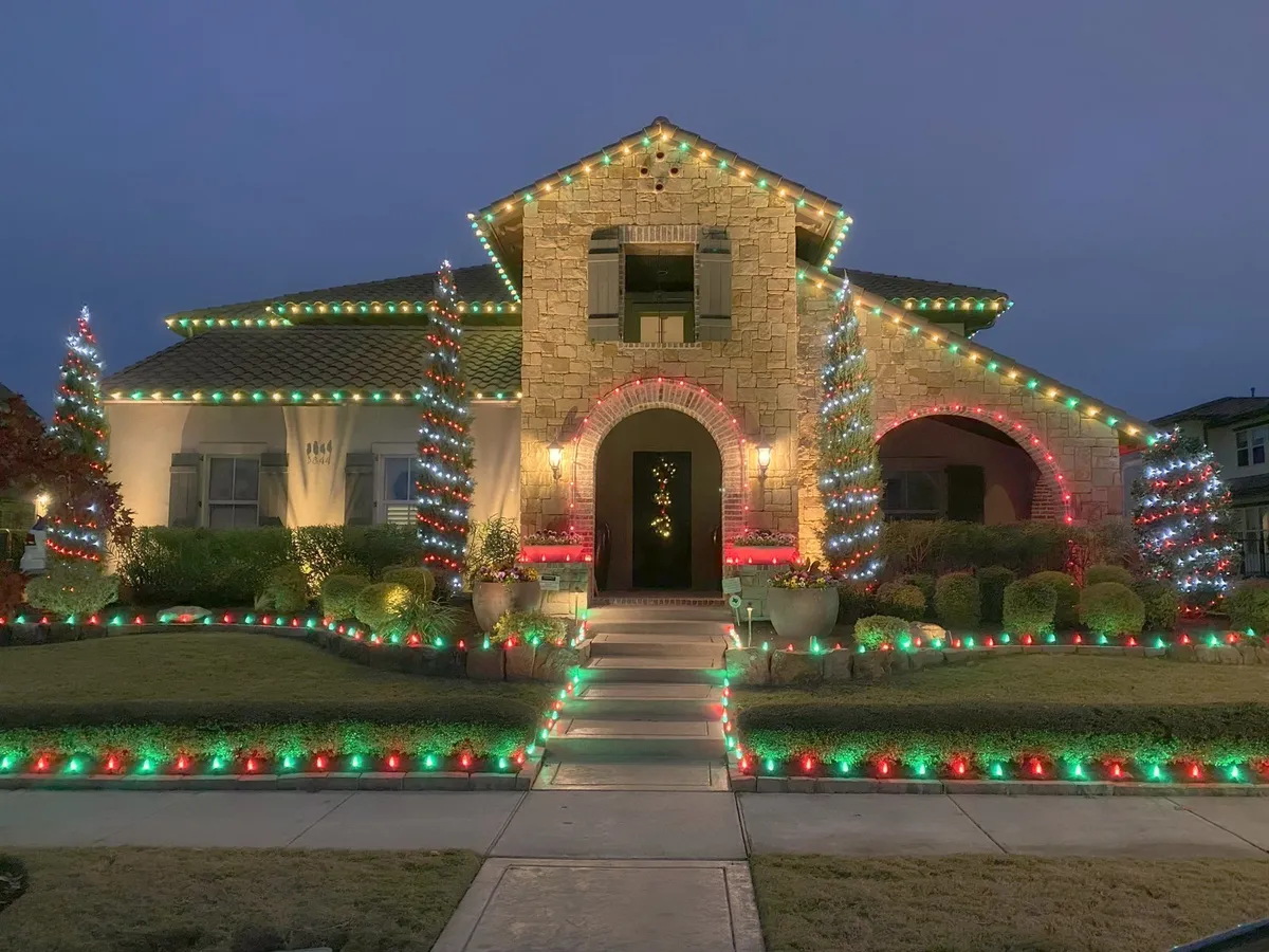 Full property in red and green on roofline, trees, beds, and walkway, installed by South Custom Lighting in North Texas
